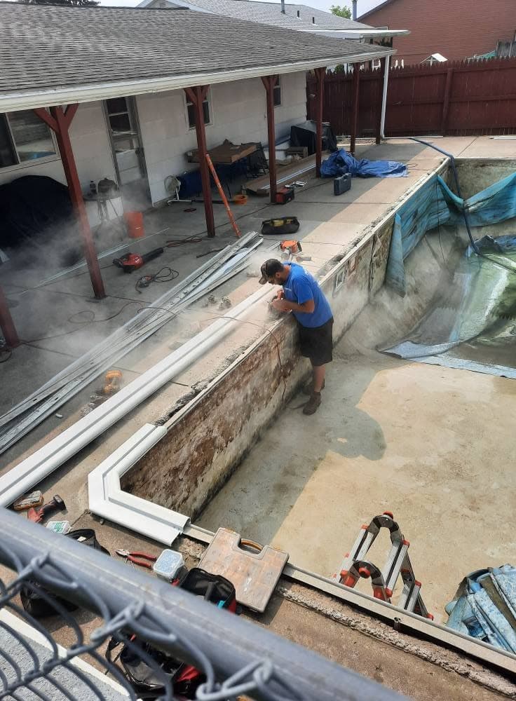 Pool Dogz crew member grinding out the old pool coping