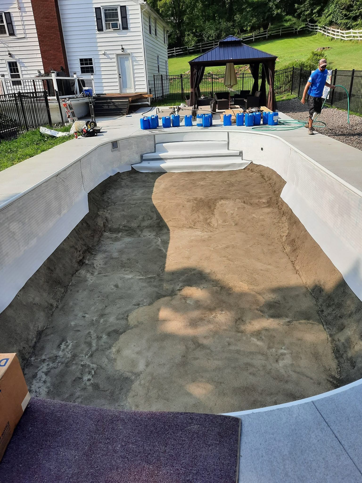 New white pool steps installed with graded base ready for liner