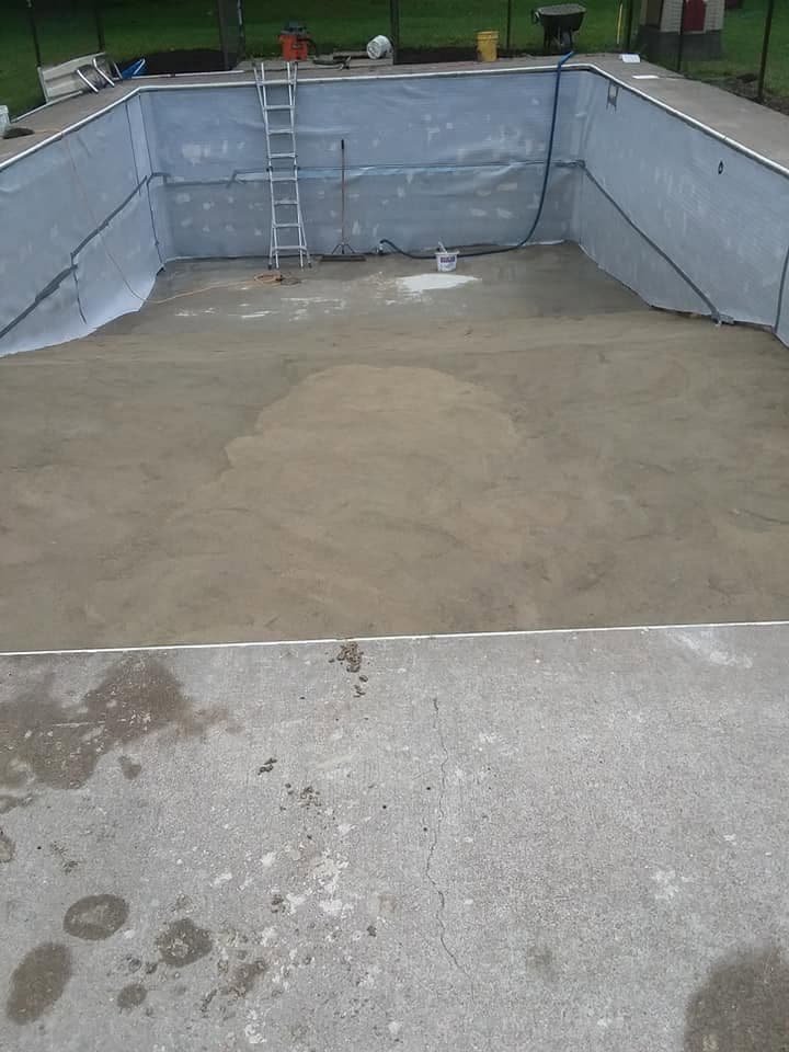 Regraded pool base troweled smooth with the shallow-to-deep transition visible