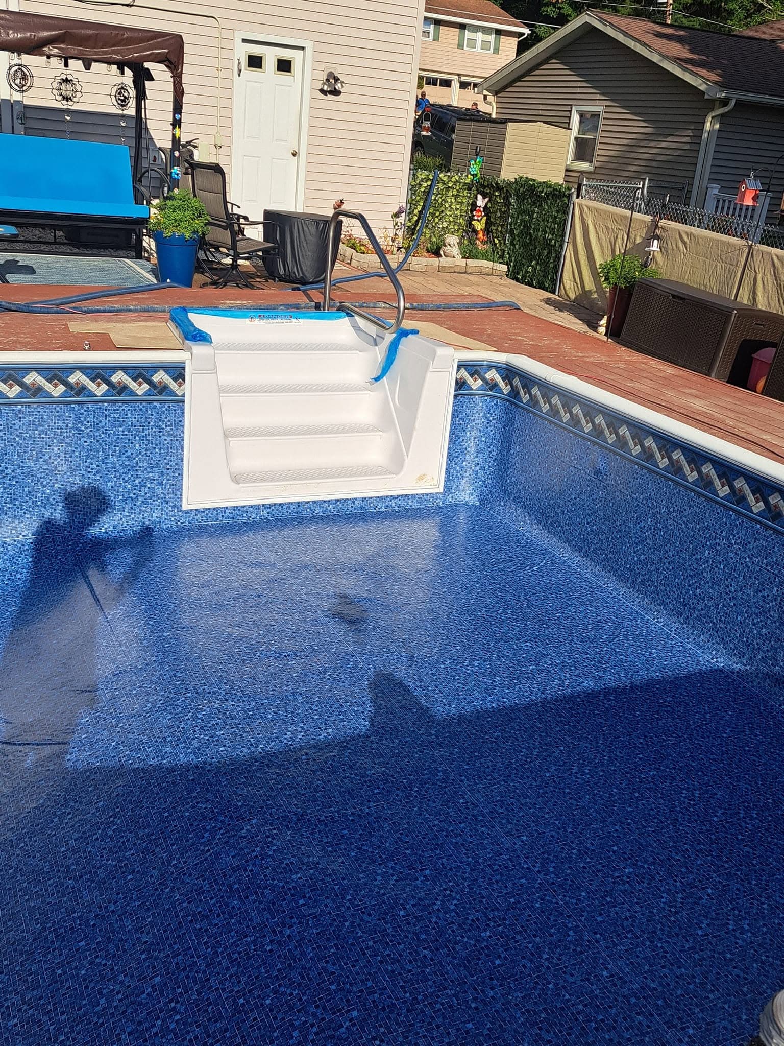 New white steps set into the fresh mosaic-pattern liner