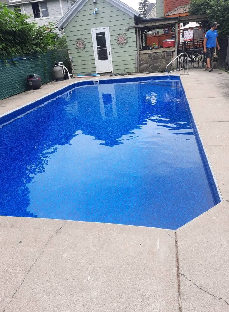 Pool after: new liner and deep blue water from the same viewpoint